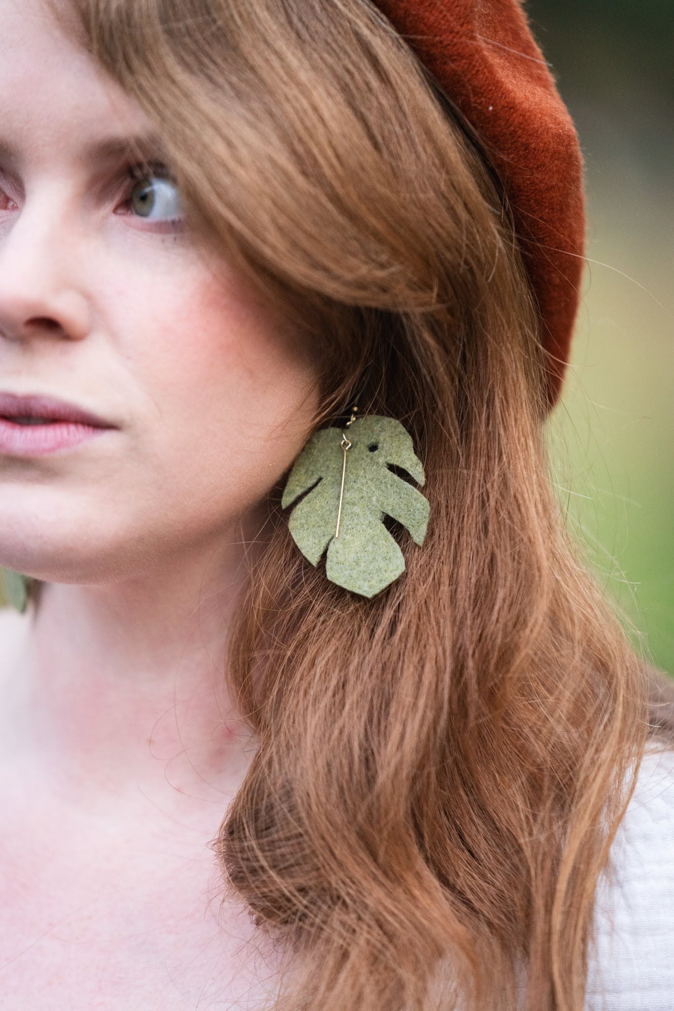 Model wearing a Jade Monstera Leaf felt earring